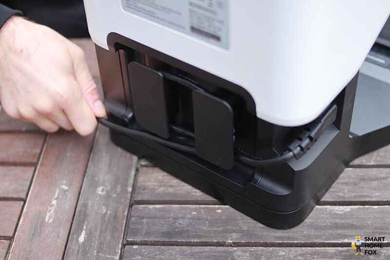 The power cable from the Roborock Q7 Max+ emptying station is rolled up.